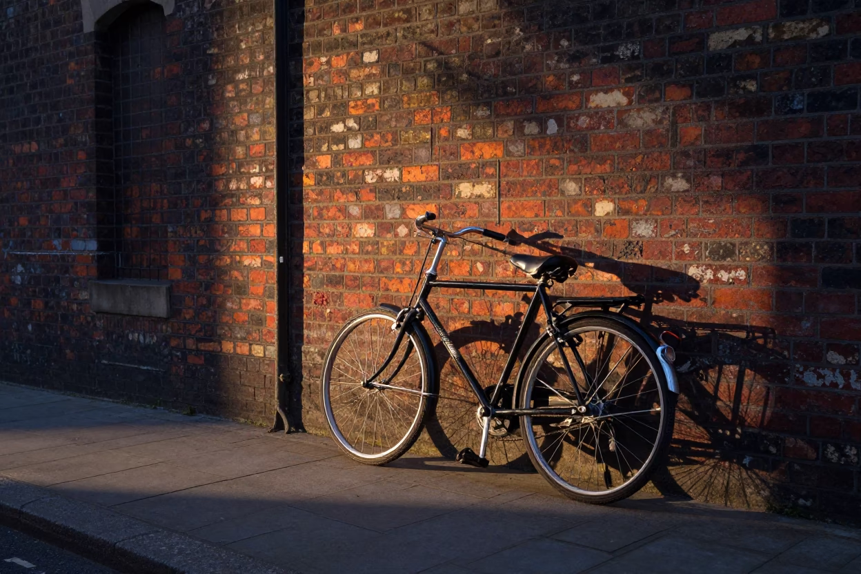 Vintage Bicycle Leaning Against Brick Wall in London Before Dawn in in London, United Kingdom