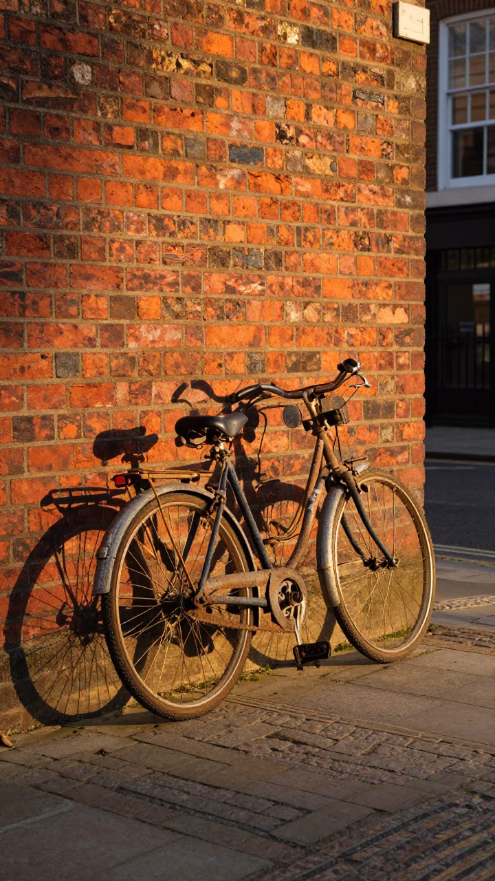 Vintage Bicycle Leaning Against Brick Wall in London Sunset Street Scene in in London, United Kingdom