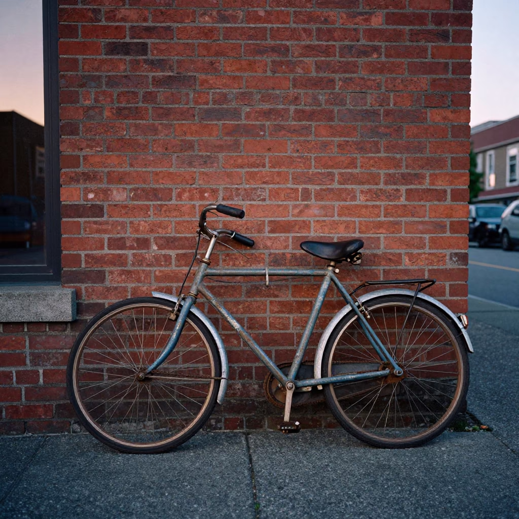 Vintage bicycle leaning against brick wall in Vancouver British Columbia before sunrise street scene in in Vancouver, British Columbia, Canada