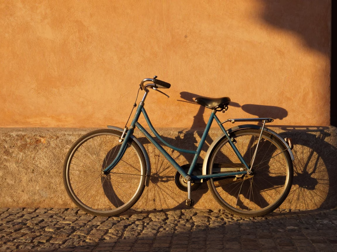 Vintage Bicycle Leaning Against Ochre Wall in Madrid During Golden Hour in in Madrid, Spain