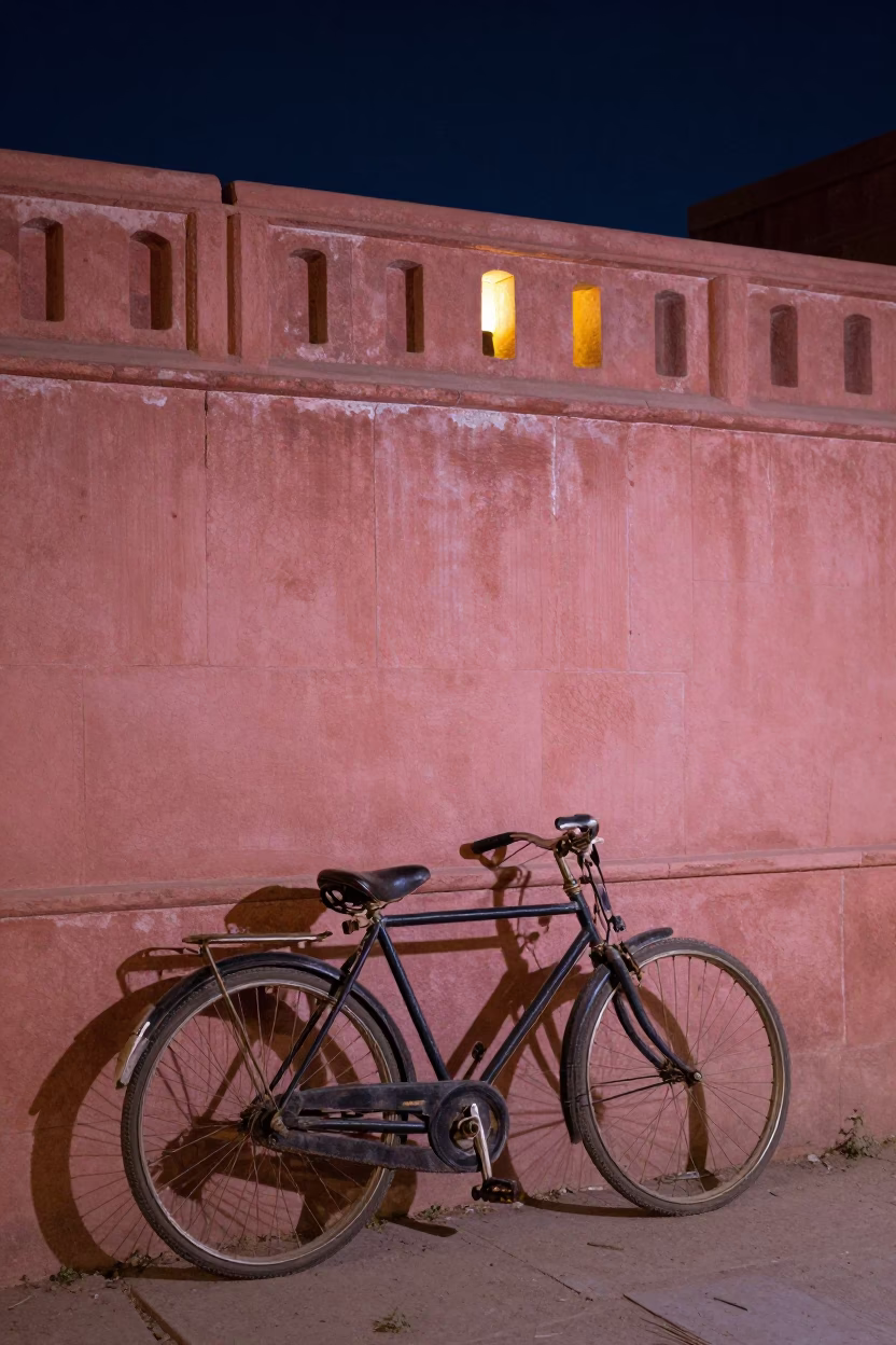 Vintage Bicycle Leaning Against Pink Sandstone Wall Under Deep Night Sky in Jaipur India in in Jaipur, India