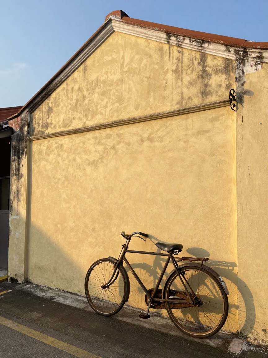 Vintage Bicycle Leaning Against Shophop Wall in George Town Early Morning Street Scene in in George Town, Malaysia