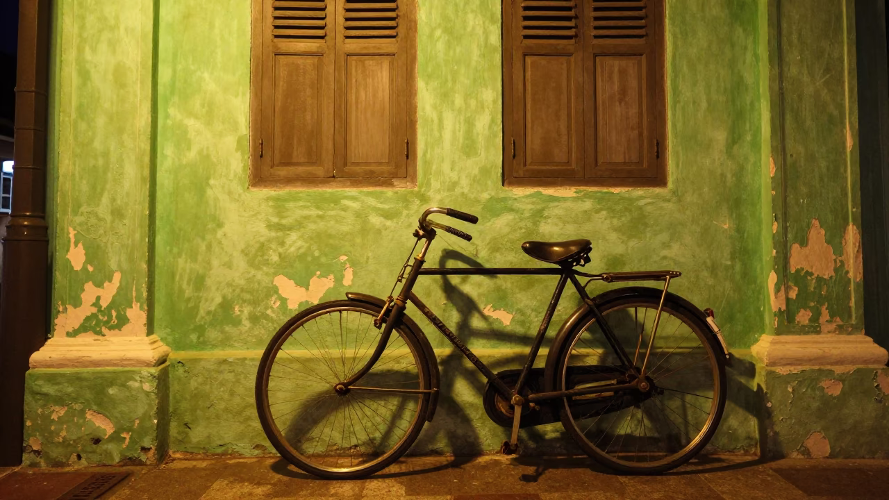 Vintage Bicycle Leaning Against Shophouse Wall in George Town Malaysia Night in in George Town, Malaysia