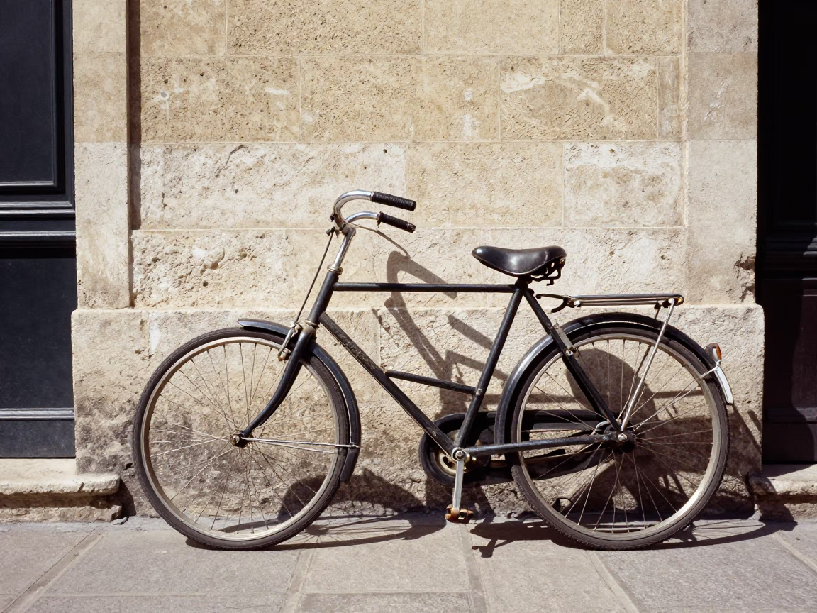 Vintage Bicycle Leaning Against Stone Wall in Historic Lyon France Midday Street Scene in in Lyon, France