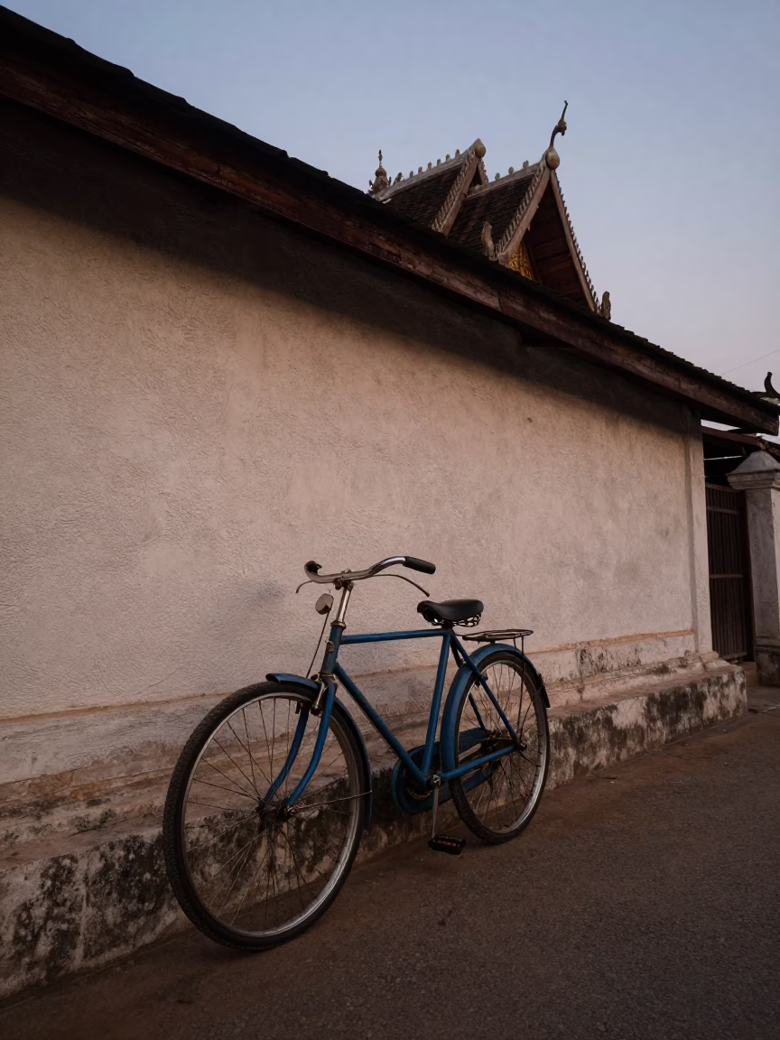 Vintage Bicycle Leaning Against Temple Wall in Chiang Mai Before Dawn in in Chiang Mai, Thailand