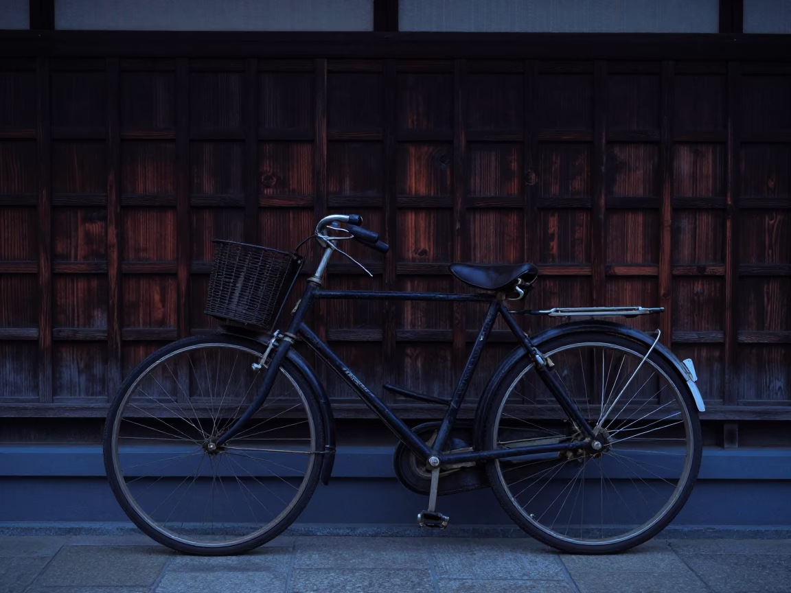 Vintage Bicycle Leaning Against Traditional Kyoto Wooden Wall Before Dawn in in Kyoto, Japan