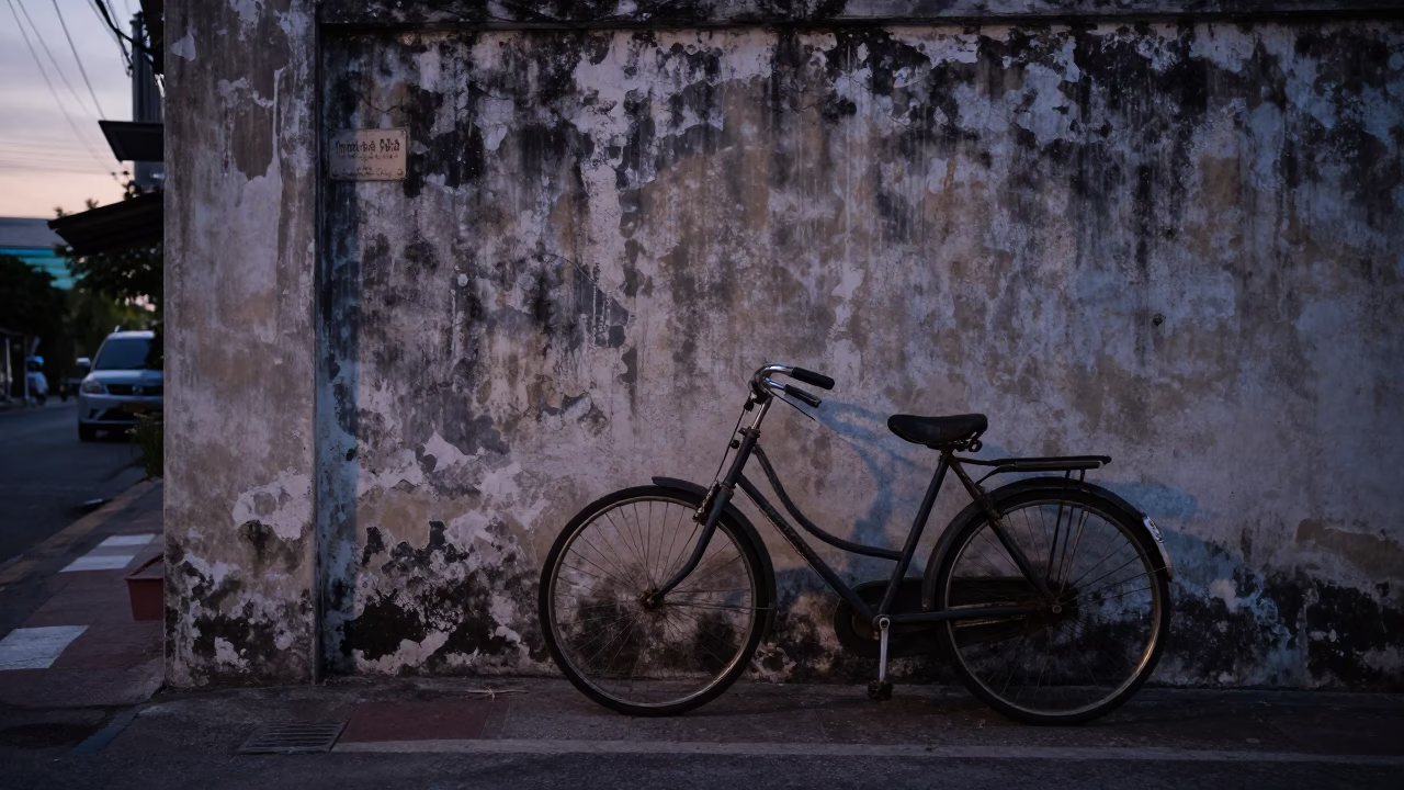 Vintage Bicycle Leaning Against Wall in Pre-Dawn Phuket Thailand Street Scene in in Phuket, Thailand