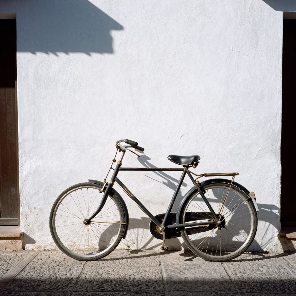 Vintage Bicycle Leaning Against White Stucco Wall in Granada Spain Midmorning Sunlight in in Granada, Spain