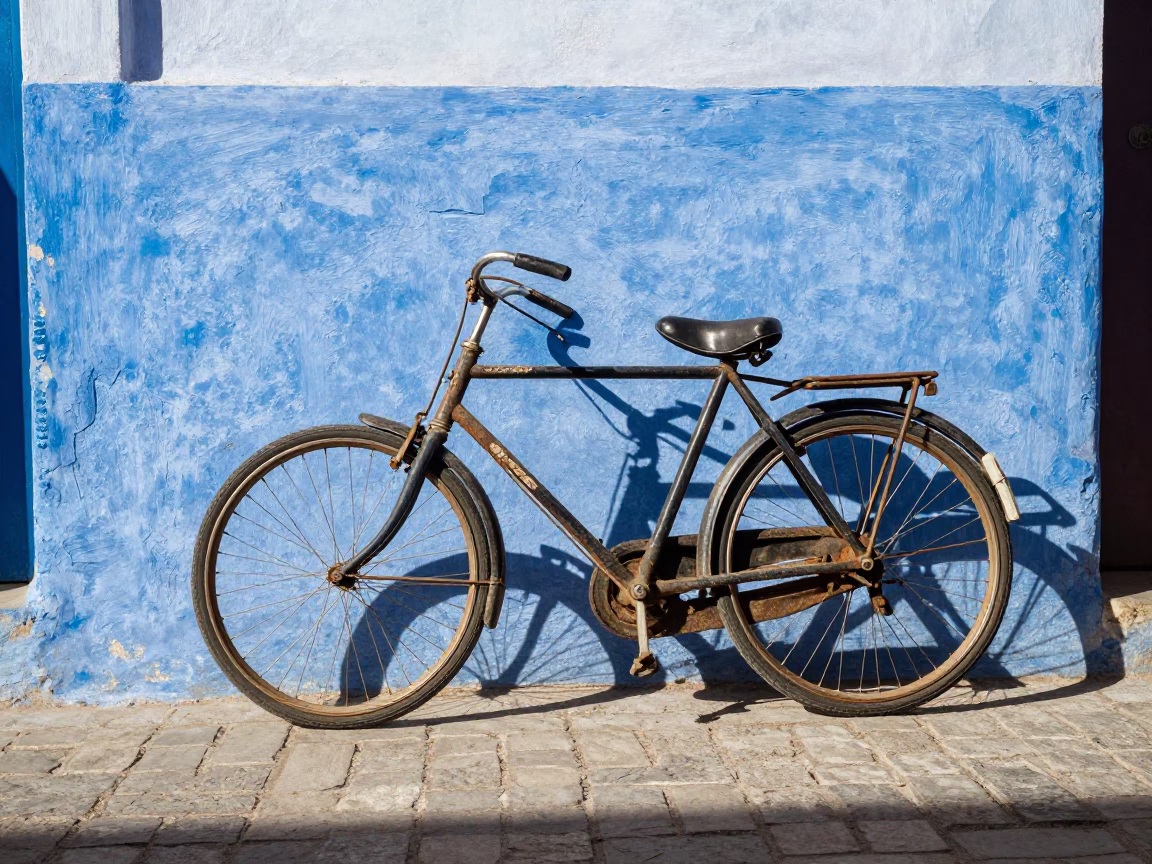 Vintage Bicycle Parked Against Blue Wall in Essaouira Morocco Midmorning in in Essaouira, Morocco