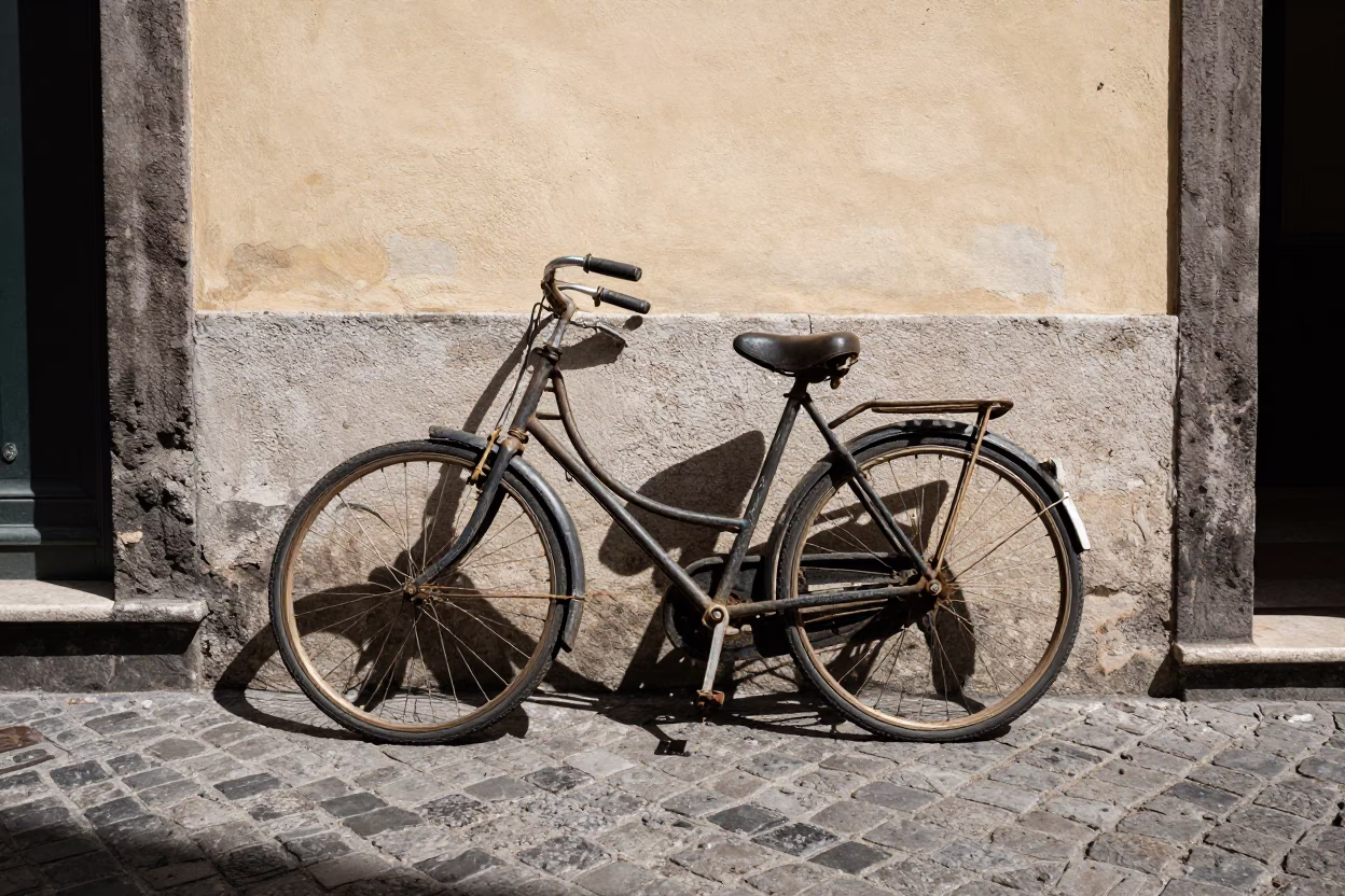 Vintage Bicycle Parked Against Sunlit Stucco Wall in Naples Italy Midday Street Scene in in Naples, Italy