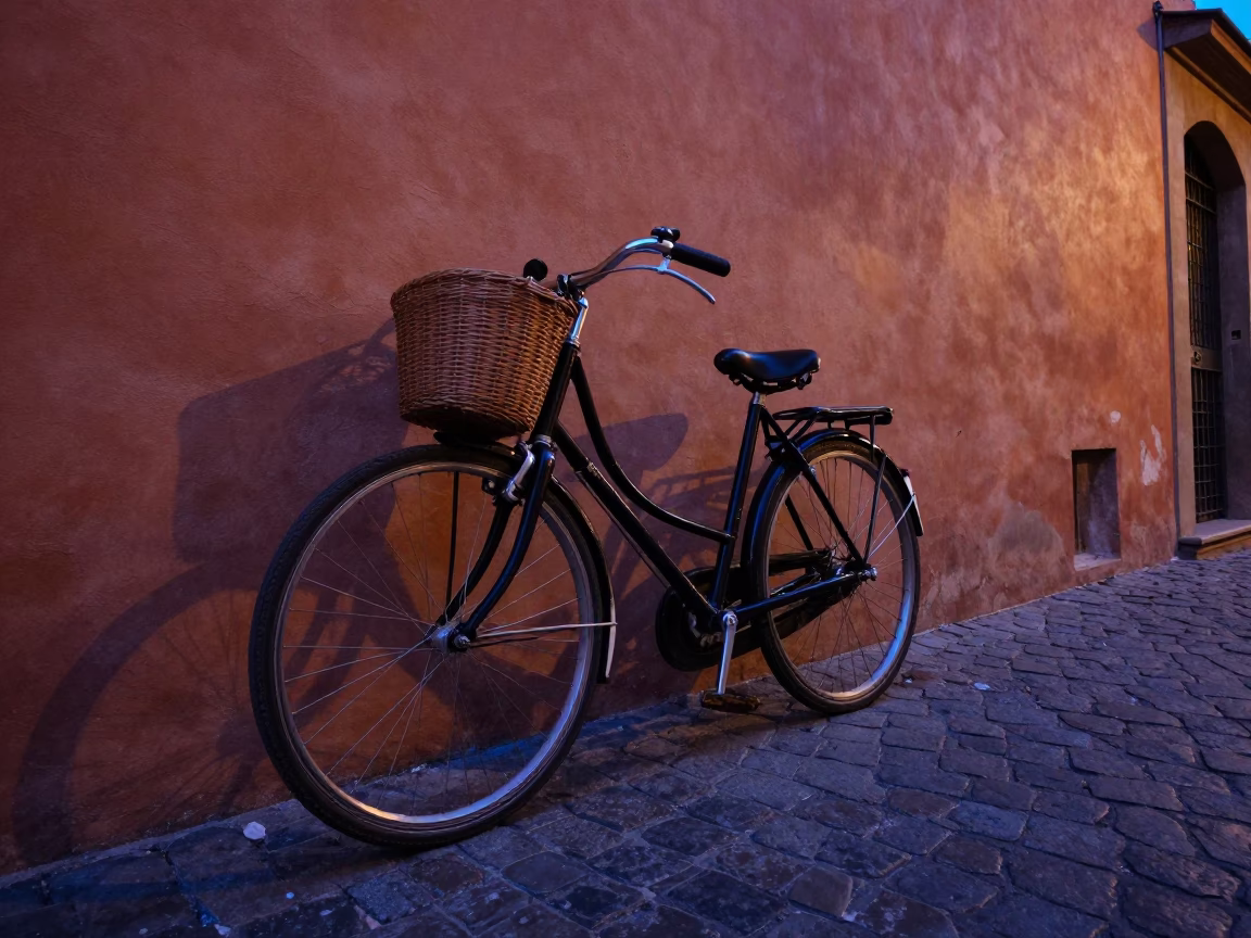 Vintage Bicycle Parked Against Terracotta Wall in Bologna Italy During Indigo Twilight in in Bologna, Italy