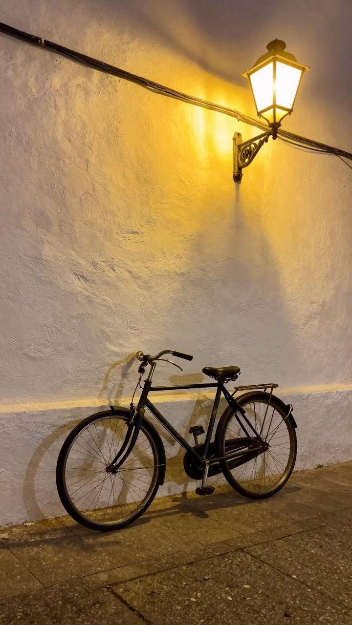 Vintage Bicycle Parked Against White Wall in Granada Spain Late Night Street Scene in in Granada, Spain