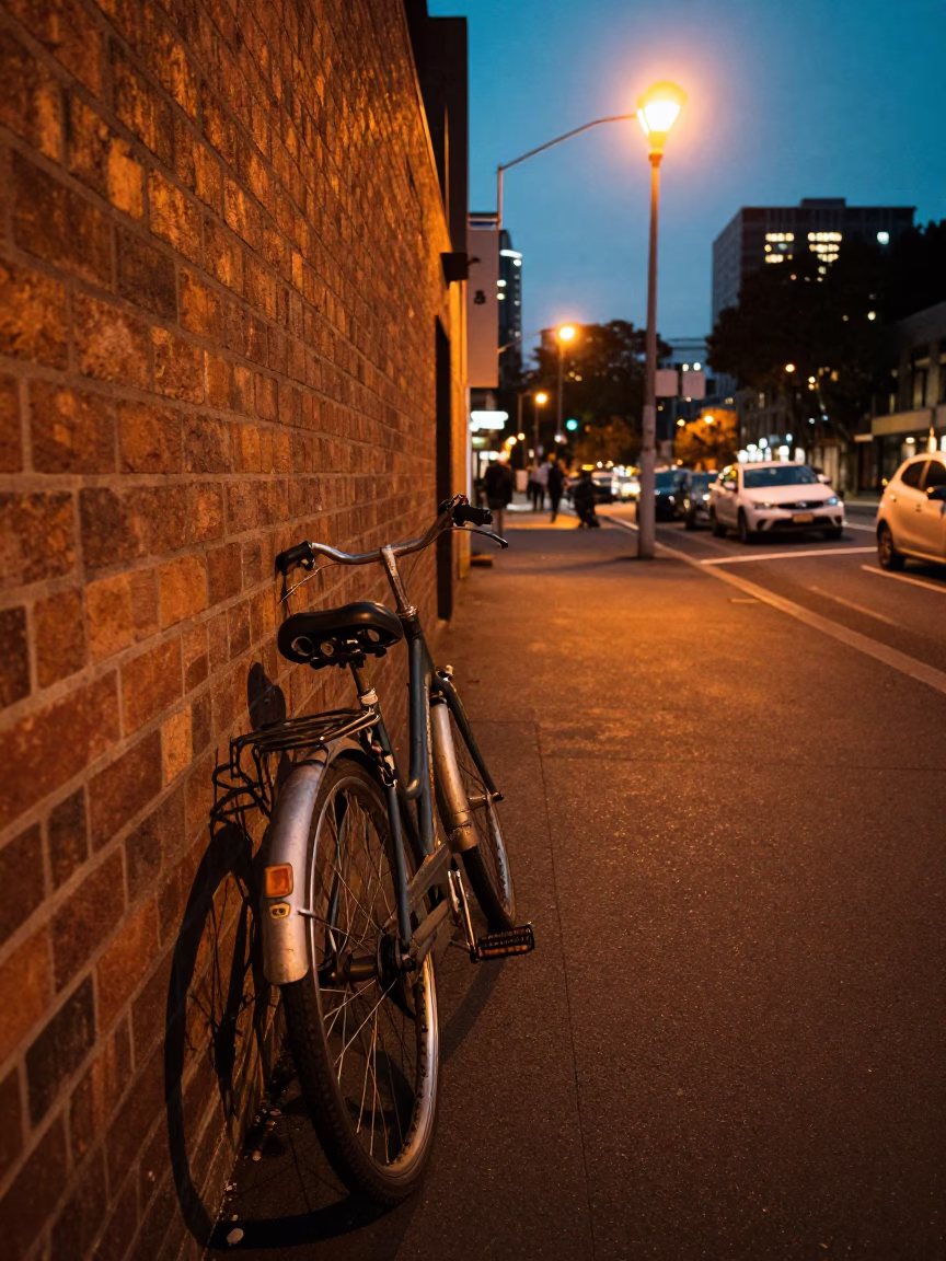 Vintage Bicycle Parked on Melbourne Footpath at Dusk with Sodium Street Lights in in Melbourne, Victoria, Australia