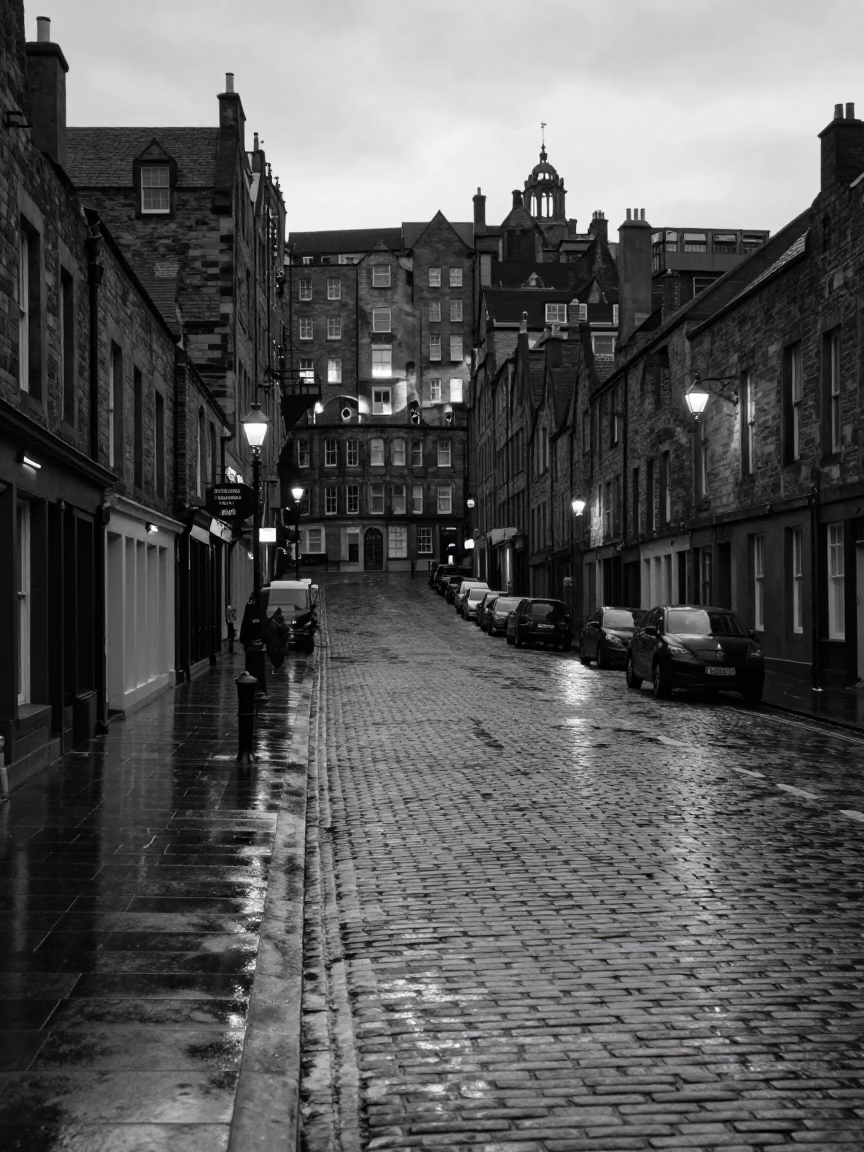 Vintage Edinburgh Street Scene Before Sunrise with Wet Pavement and Historic Architecture in in Edinburgh, United Kingdom