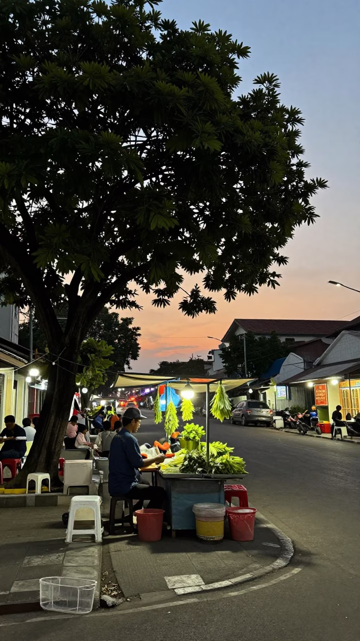 Vintage Evening Street Scene in Surabaya Indonesia with Tree and Herb Vendor in in Surabaya, Indonesia