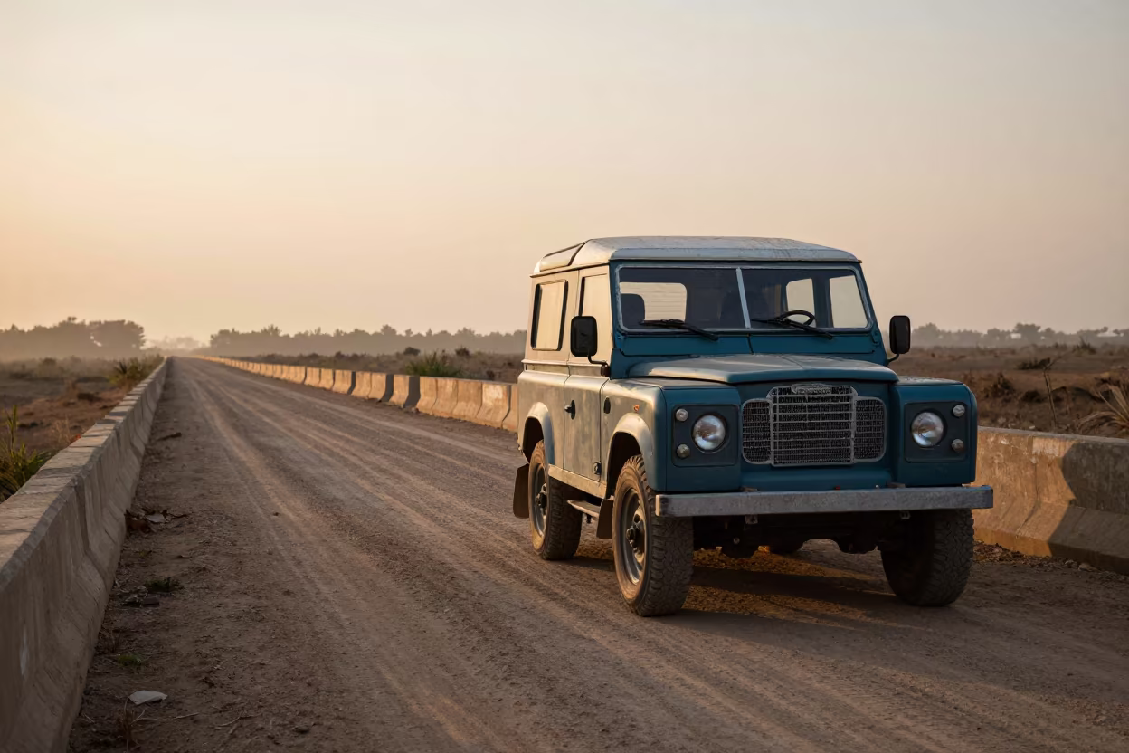 Vintage Land Rover on Sokodé Causeway at Golden Hour in on a wind-open causeway near Sokodé