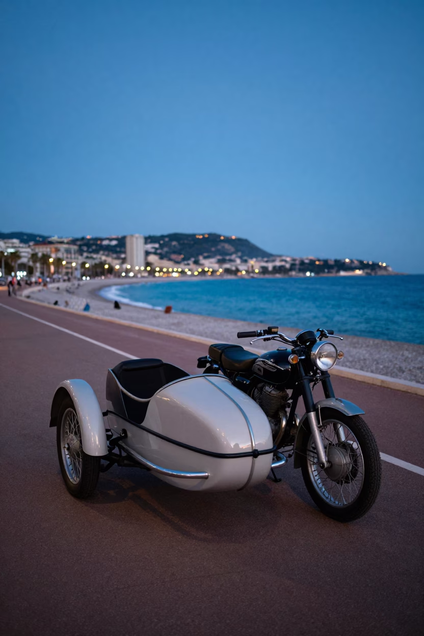 Vintage motorcycle with sidecar parked on Nice promenade during blue hour twilight in in Nice, France