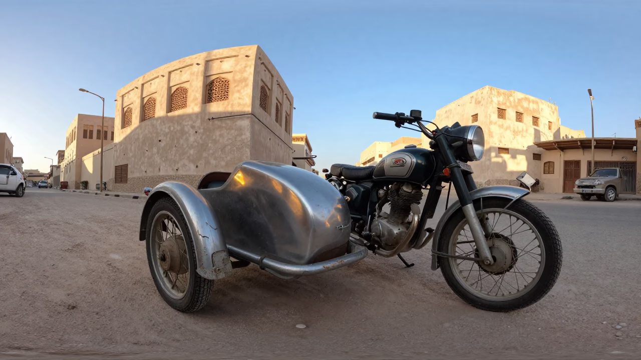 Vintage Motorcycle with Sidecar Parked Outside Traditional Omani Building in Late Afternoon Light in in Muscat, Oman