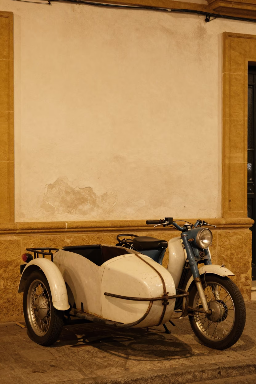 Vintage Motorcycle With Sidecar Parked Outside Traditional Seville Building At Night in in Seville, Spain