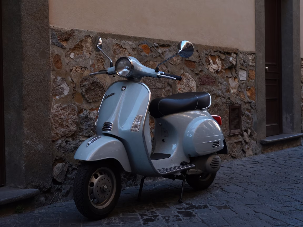 Vintage Vespa parked on cobblestone lane in Florence Italy before sunrise in in Florence, Italy
