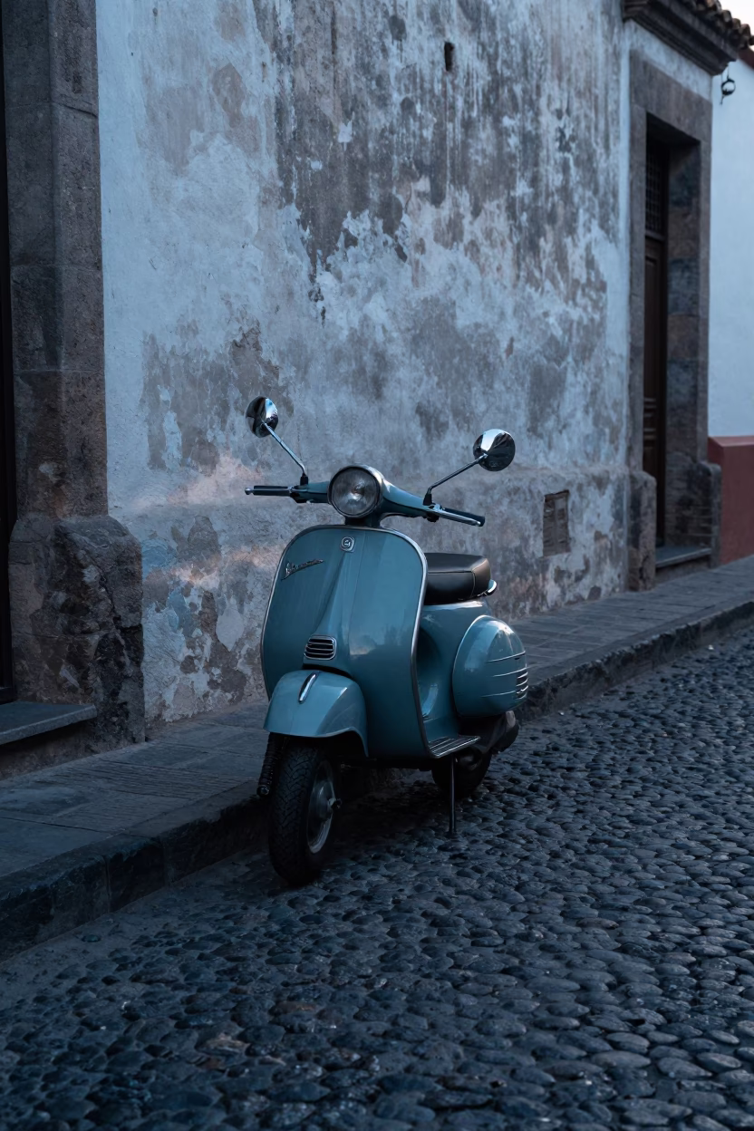 Vintage Vespa Parked on Cobblestone Street in Pre-Dawn Quito Ecuador in in Quito, Ecuador