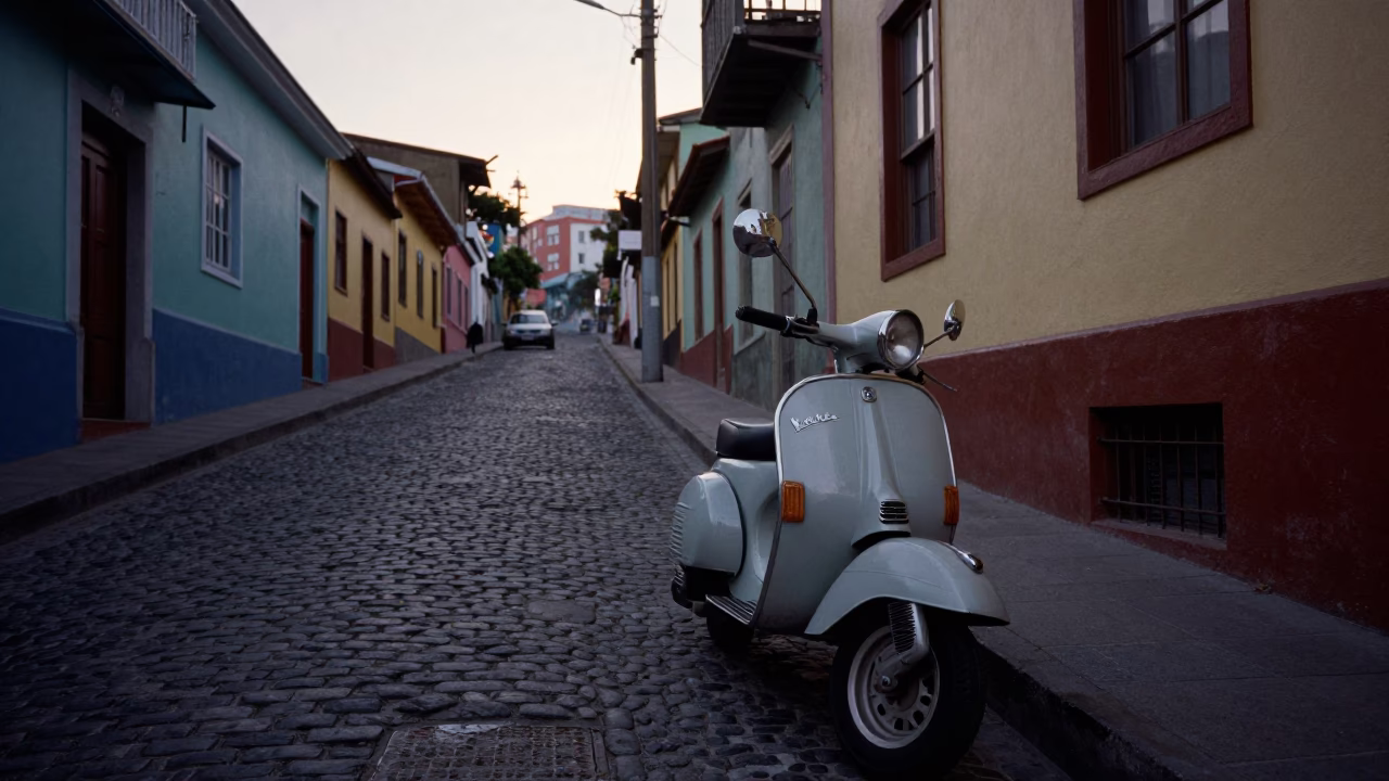 Vintage Vespa parked on cobblestone street in Valparaiso Chile before sunrise in in Valparaiso, Chile