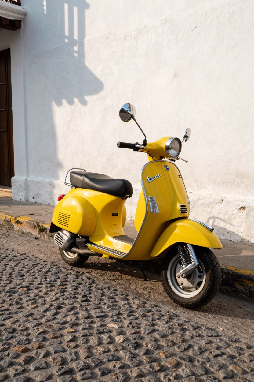 Vintage Vespa parked on colonial cobblestone street in Cartagena Colombia late morning in in Cartagena, Colombia