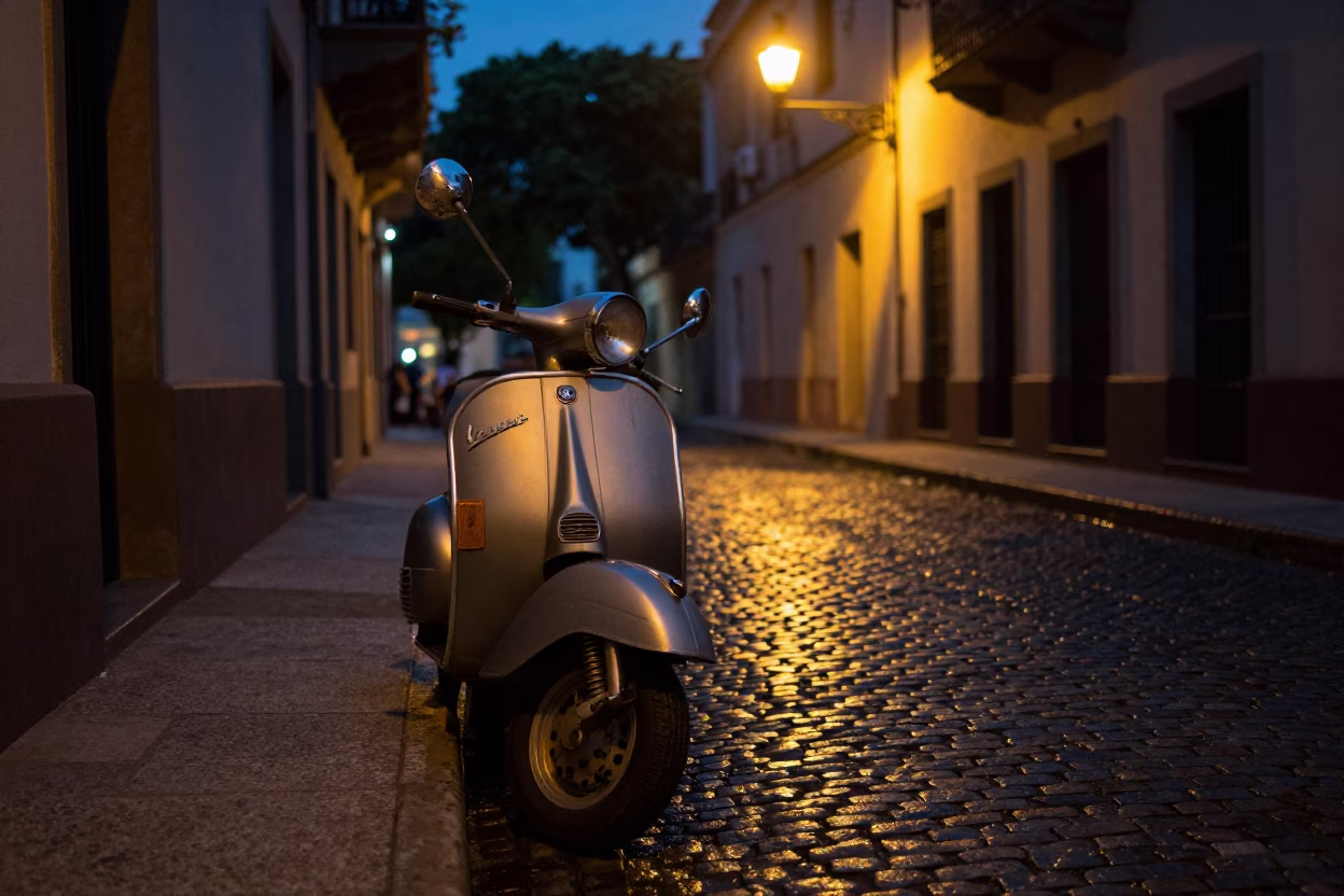 Vintage Vespa parked on dim cobblestone street in Buenos Aires at predawn in in Buenos Aires, Argentina