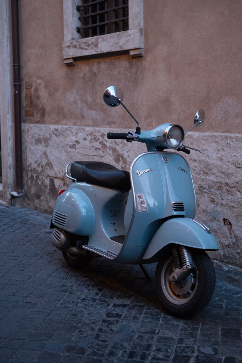 Vintage Vespa Parked on Roman Cobblestone Street Under Evening Blue Light in in Rome, Italy