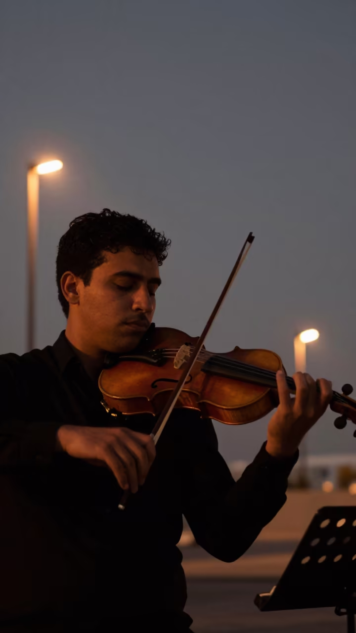 Violinist Bows Sustained Note Late Night Abu Dhabi in on a dimly lit stage in Abu Dhabi
