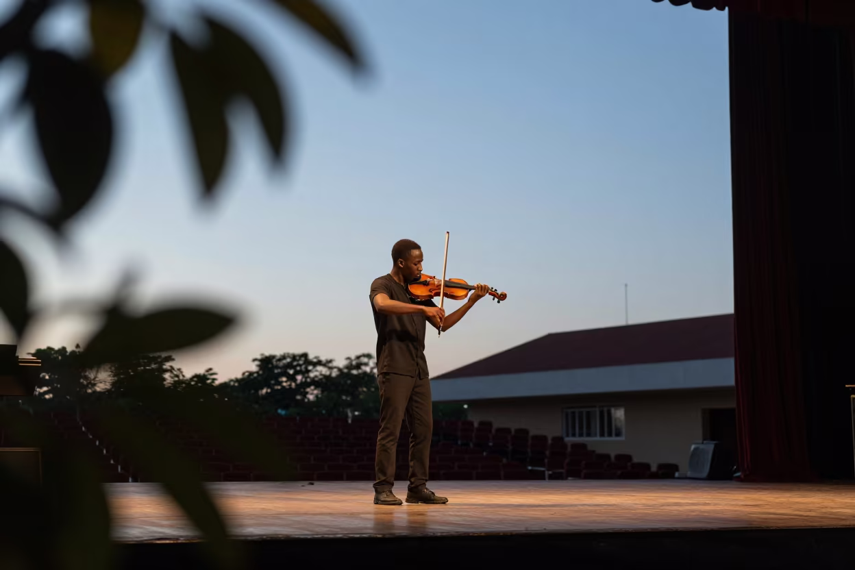 Violinist Solo on Stage at Sunset in Bouake in on a theater stage in Bouake