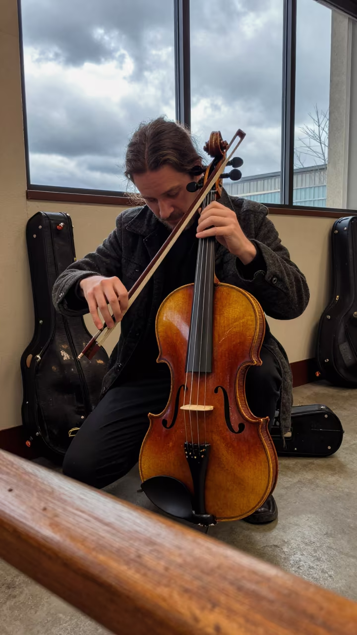 Violinist Tuning Instrument Backstage Salem Hall in in a concert hall in Salem