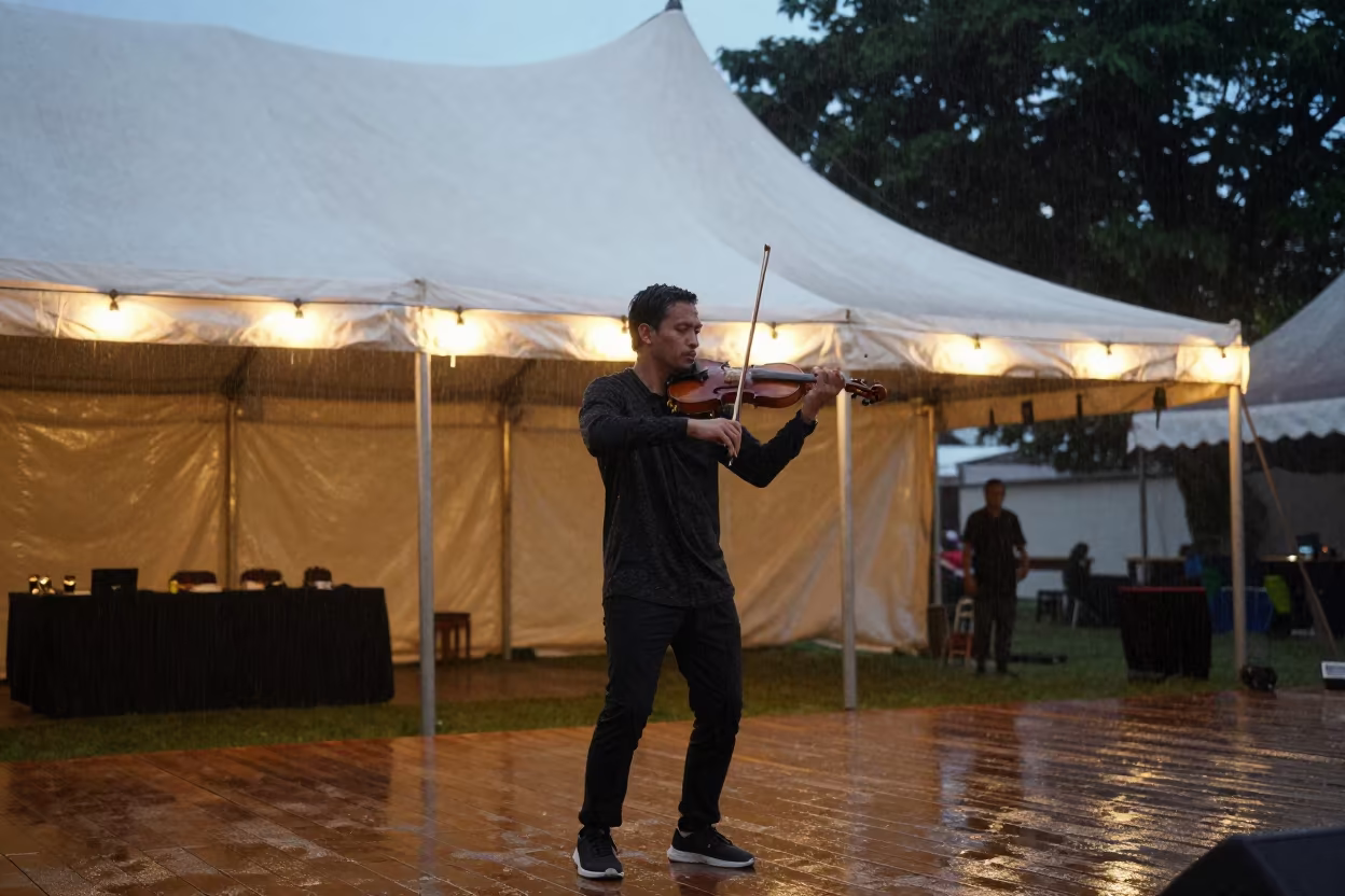 Violinist Under Circus Tent in Semarang Rain in under a circus tent in Semarang