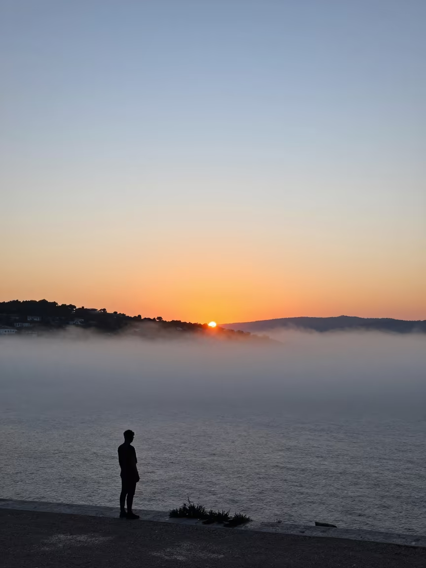 Virga Falling Through Split Fog at Sunset in through low marine fog near Split