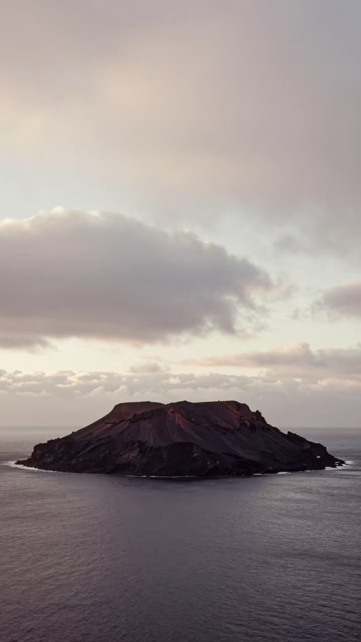 Volcanic Island Silhouette Against Overcast Dawn in near Lhasa