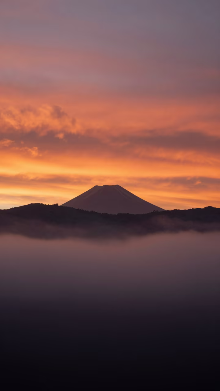 Volcanic Sunset Layers Through Fog in Peru in through low marine fog in Peru