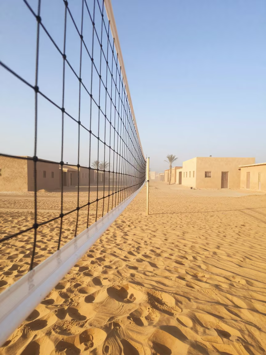 Volleyball Net Trembling Over Hot Sand at Dawn in in a village lane near Agadir