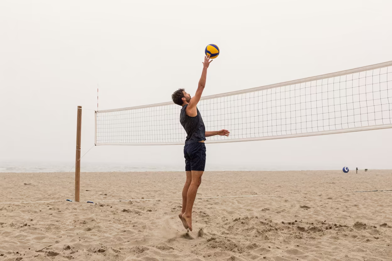 Volleyball Player Spiking Net Beach Drizzle in along a beach near Bolu