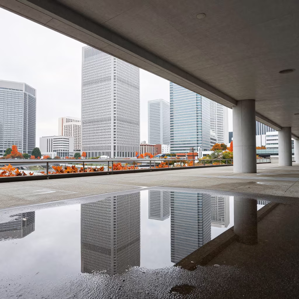 Warped Skyscraper Reflections in Yokama Puddle in inside a skylit passageway in Yokohama