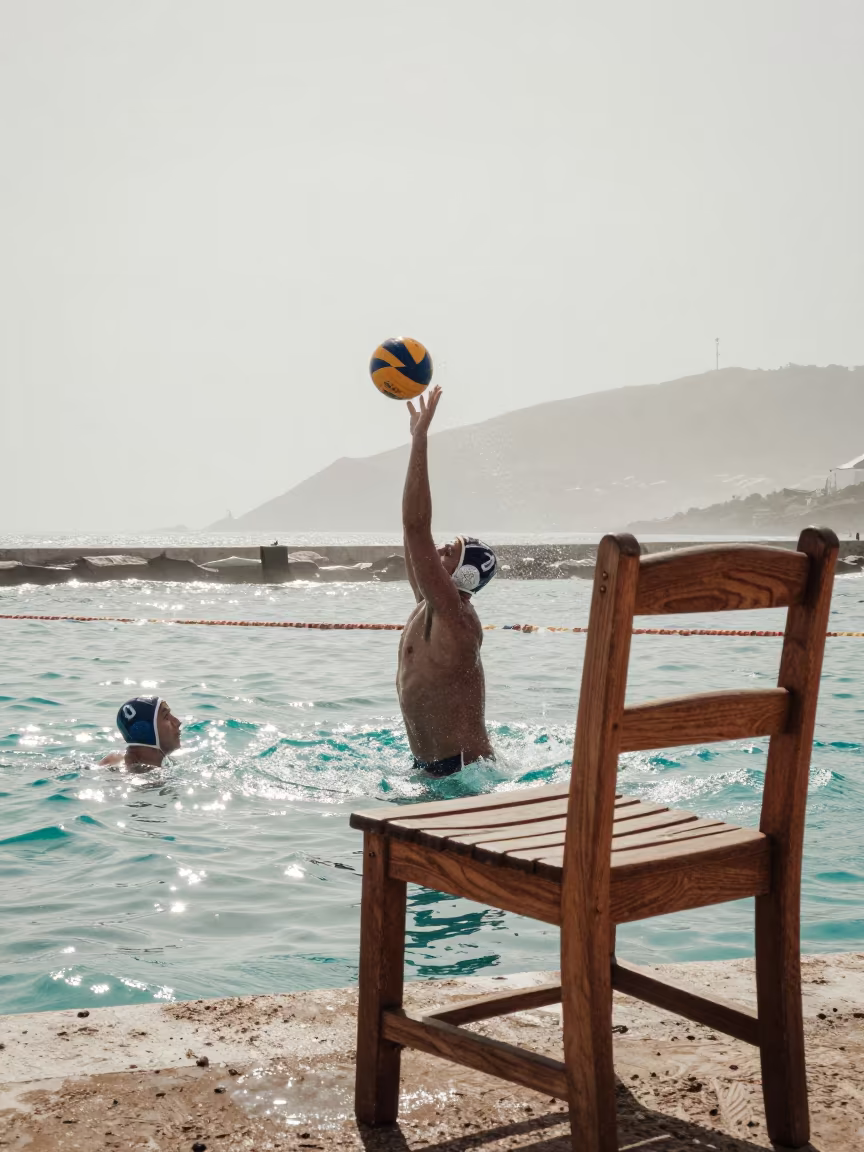 Water Polo Goalkeeper Blocks Shot Amid Stone Furniture in at a harbor quay near Navojoa