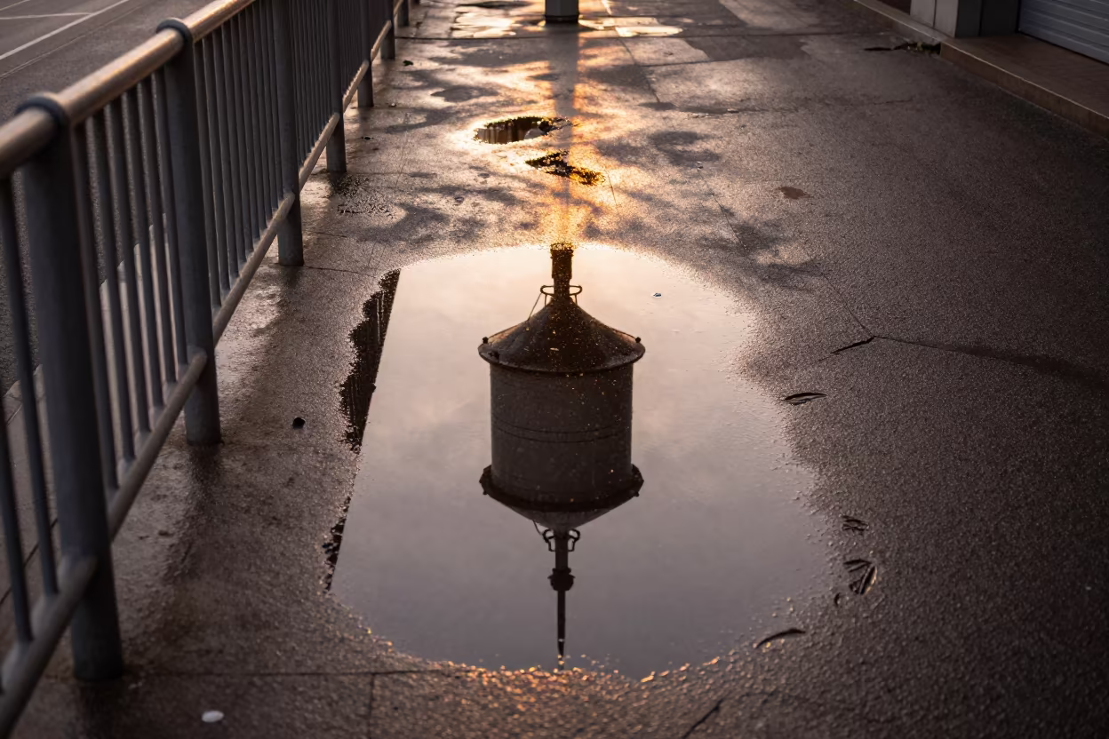 Water Tower Reflection on Wet Rooftop Alley in at a tram stop in Manta