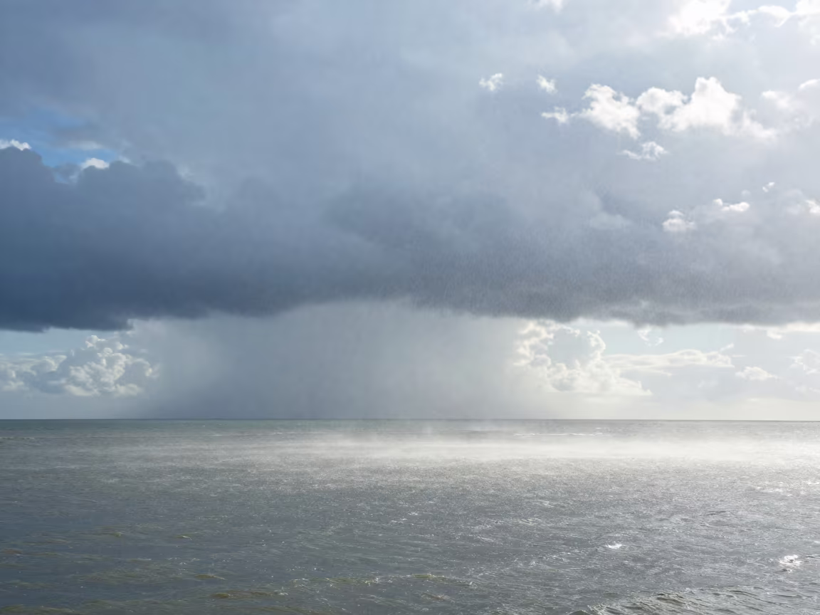 Waterspout Rising Over Stacked Thunderheads in over a horizon of stacked thunderheads in Goa