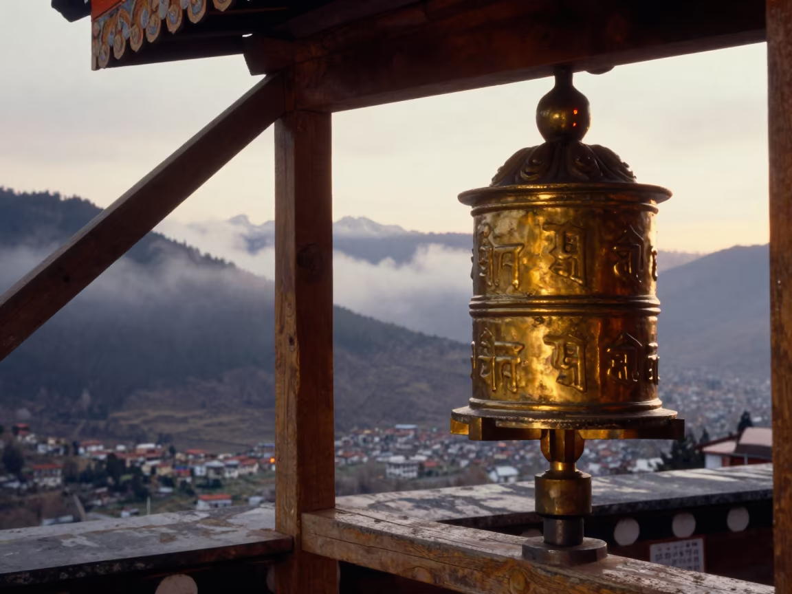 Weathered Hand Spins Prayer Wheel on Rooftop in on a monastery rooftop above a mountain valley near Thimphu