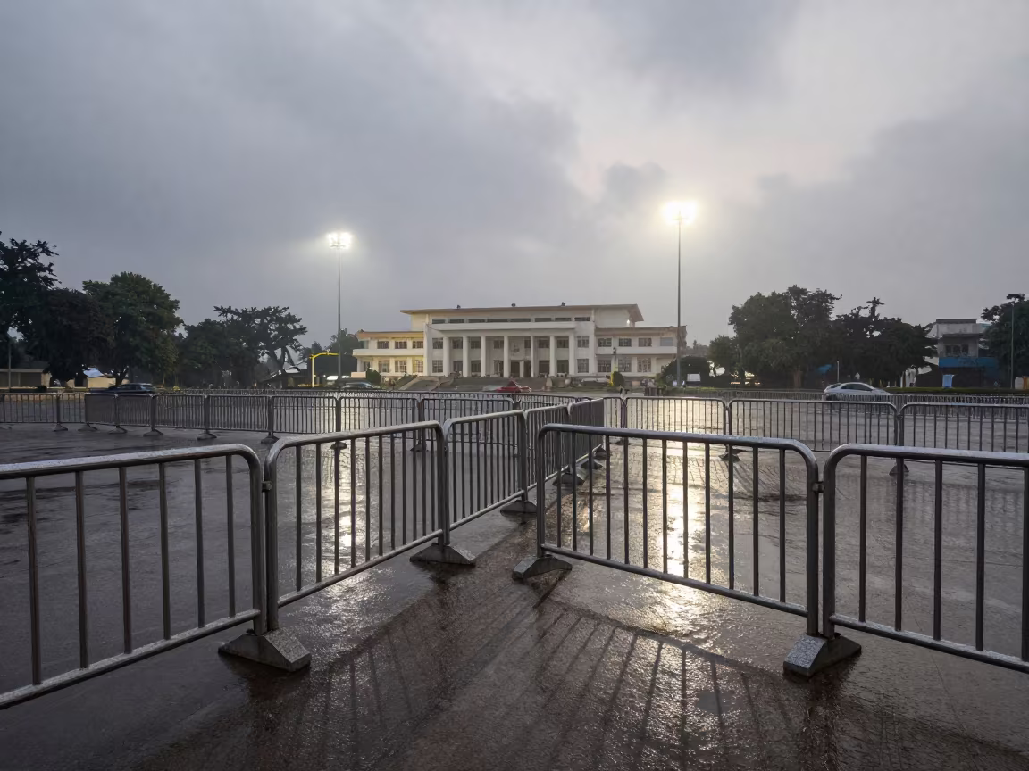Wet Civic Barricades Under Dawn Floodlights in beneath government building floodlights in Mandi Bahauddin
