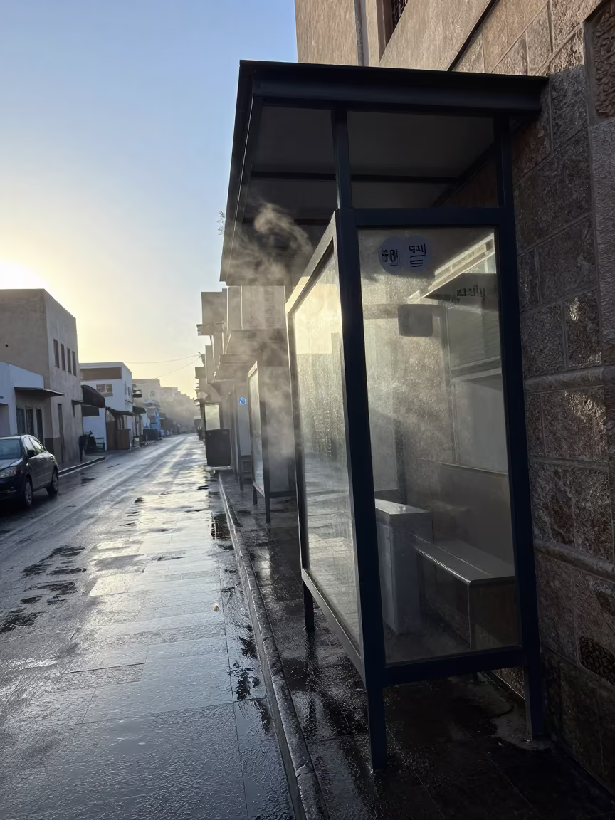 Wet Sanaa Street Dawn Bakery Reflections in beside a steamed-up bus shelter in Sanaa