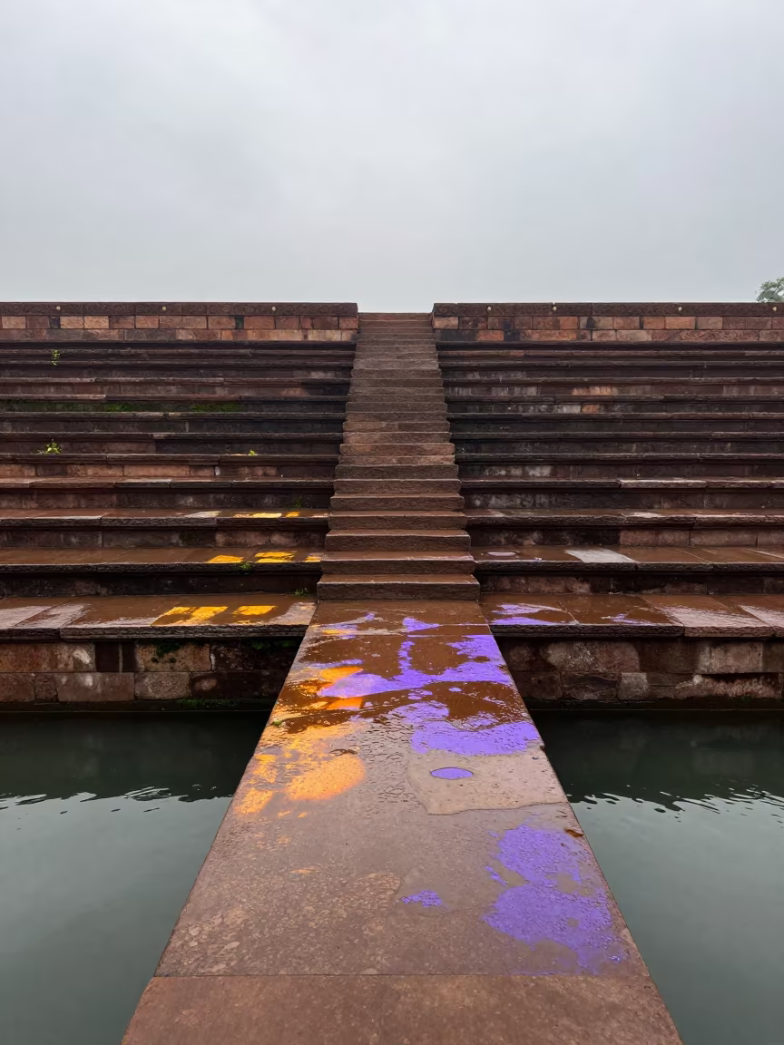 Wet Stone Ghat Steps Reflecting Sky After Monsoon in at the edge of a sacred pool in India