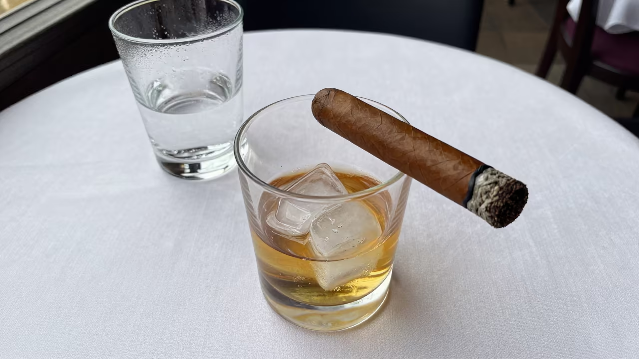 Whisky Tumbler and Cigar on Linen Table in on a linen-covered restaurant table in Gliwice
