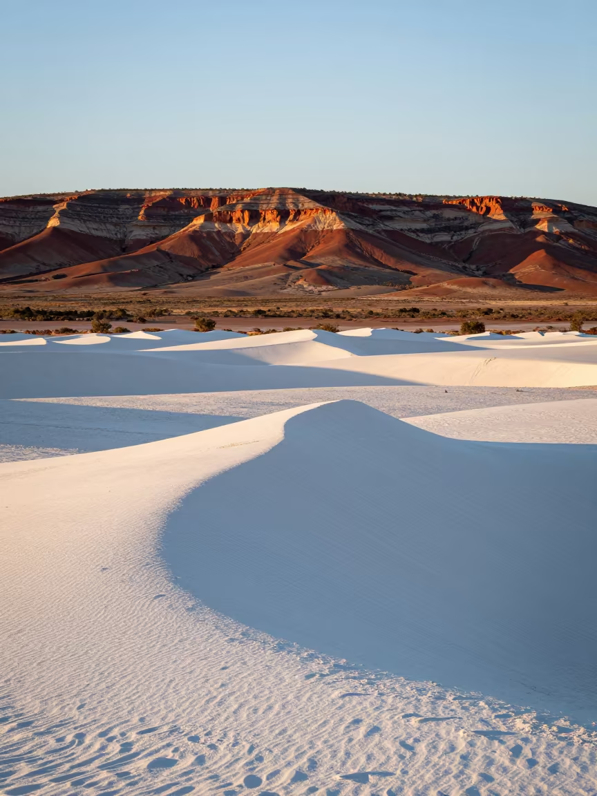 White Gypsum Dunes at Dawn in Australian Outback in from a ridge above layered foothills in Australia