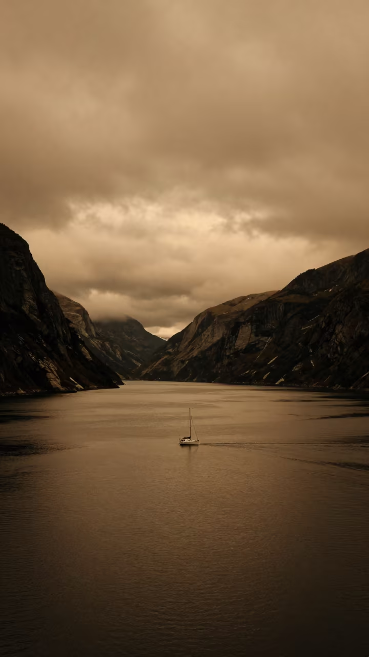 White Sail on Dark Fjord in Amber Evening Light in near Jalingo