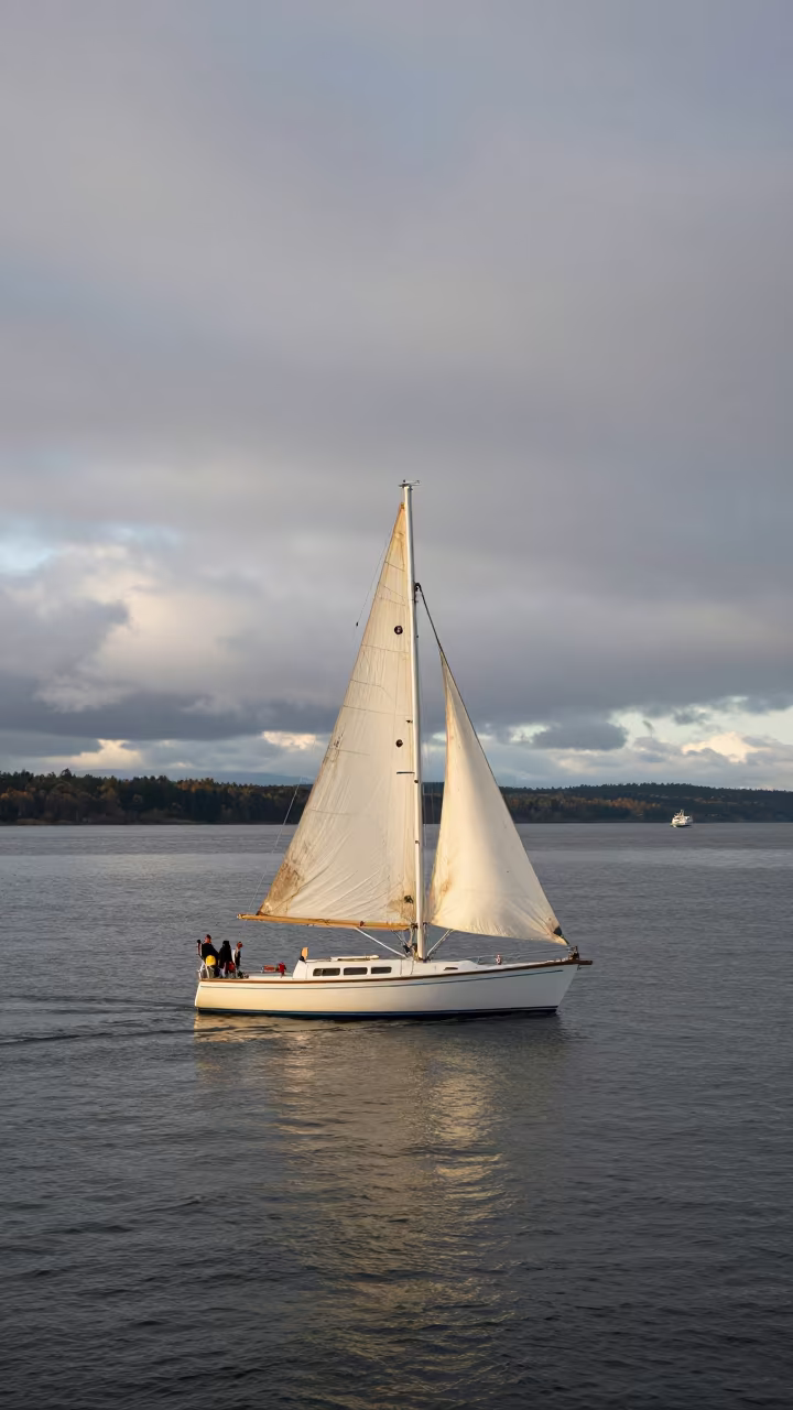 White Sailboat on Grey Sea Oregon Ferry in across a remote ferry crossing in Oregon